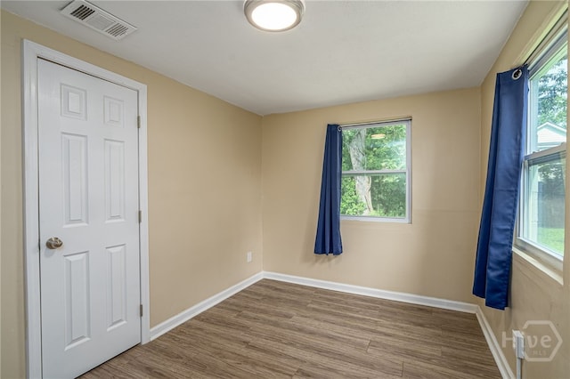 1515 Vine St, Savannah, GA 31401 - spare room with wood finished floors, healthy amount of natural light, and baseboards