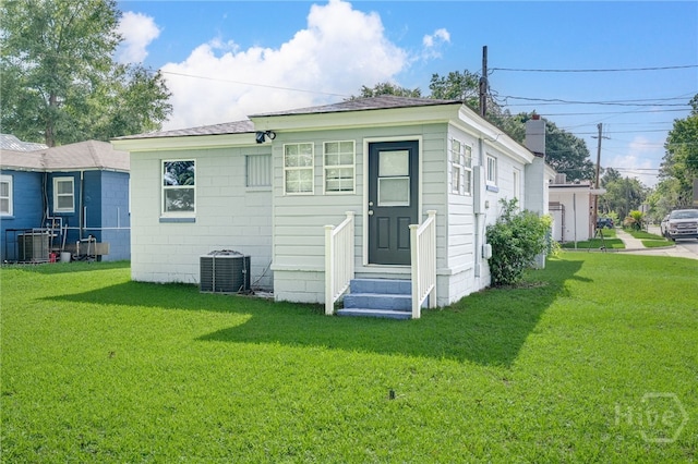 1515 Vine St, Savannah, GA 31401 - rear view of house featuring entry steps, a lawn, central air condition unit, and a chimney