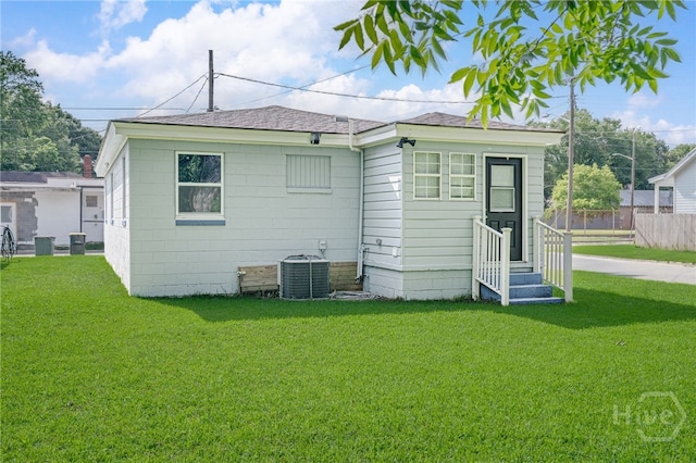 1515 Vine St, Savannah, GA 31401 - back of property with entry steps, central AC, a yard, and a shingled roof