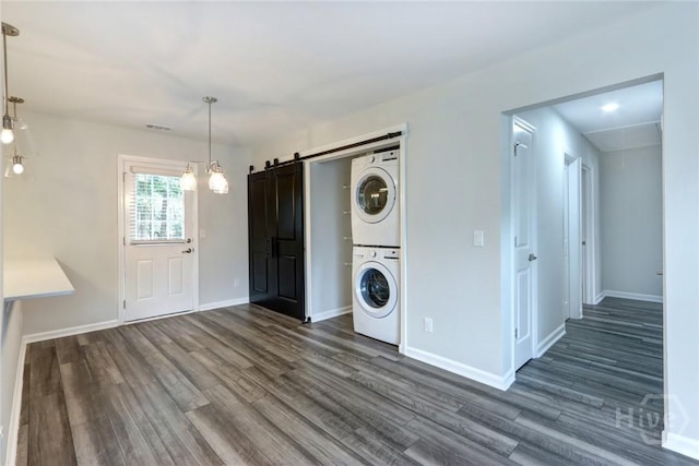 106 Oyster Catcher Ln, Savannah, GA 31410 - washroom with stacked washer and clothes dryer, attic access, dark wood-style floors, and baseboards