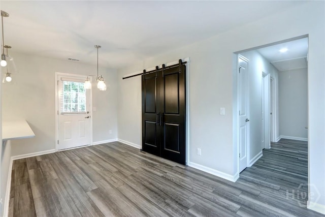 106 Oyster Catcher Ln, Savannah, GA 31410 - foyer entrance featuring wood finished floors, a barn door, and baseboards
