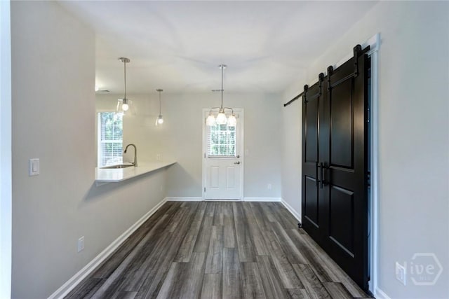 106 Oyster Catcher Ln, Savannah, GA 31410 - interior space featuring dark wood-style floors, a barn door, a sink, baseboards, and a chandelier