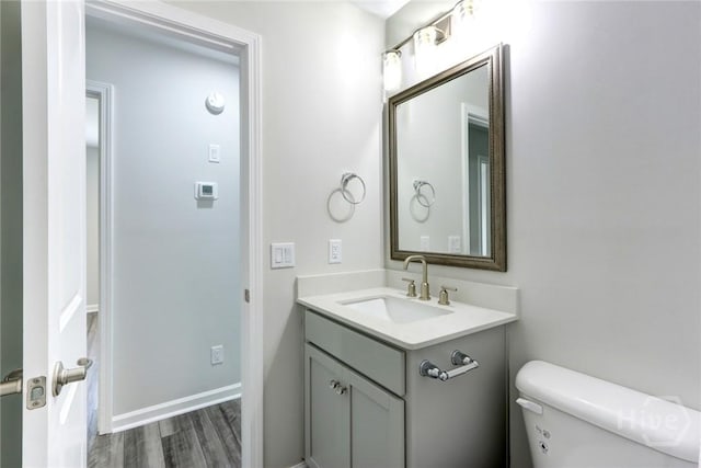106 Oyster Catcher Ln, Savannah, GA 31410 - half bathroom with toilet, vanity, wood finished floors, and baseboards
