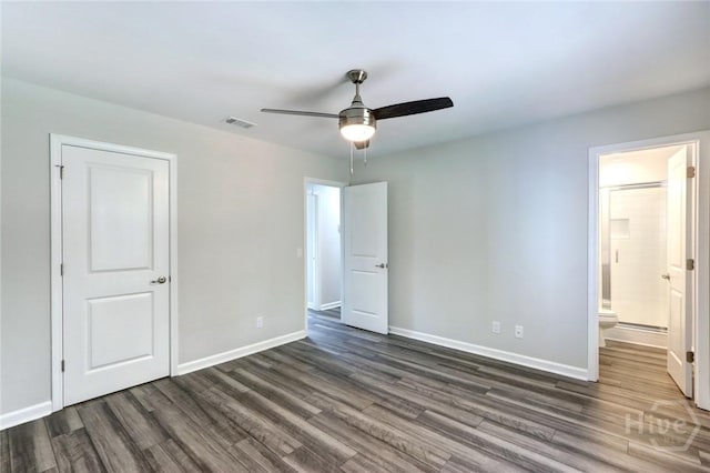 106 Oyster Catcher Ln, Savannah, GA 31410 - unfurnished bedroom featuring dark wood finished floors, baseboards, connected bathroom, and ceiling fan