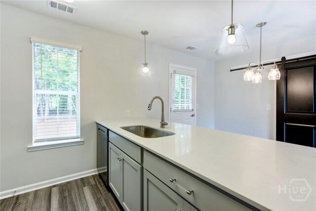 106 Oyster Catcher Ln, Savannah, GA 31410 - kitchen featuring a sink, dishwasher, dark wood-style flooring, light countertops, and gray cabinets