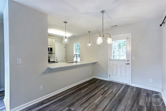 106 Oyster Catcher Ln, Savannah, GA 31410 - kitchen featuring stainless steel microwave, dark wood-style flooring, stove, and healthy amount of natural light
