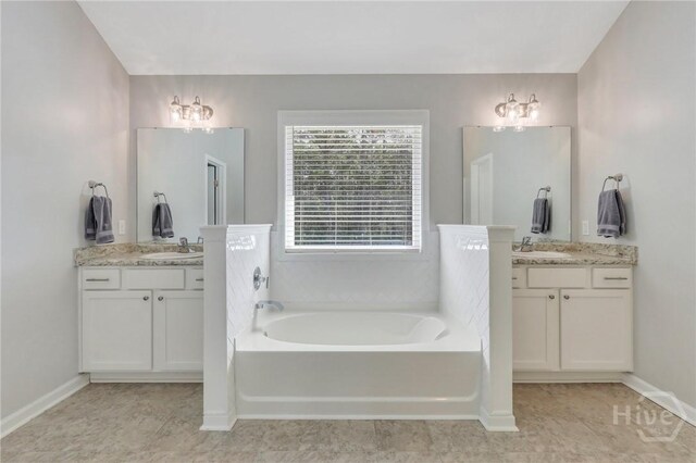 346 Bobwhite Trl NE, Ludowici, GA 31316 - bathroom featuring a bath, two vanities, baseboards, and tile patterned floors