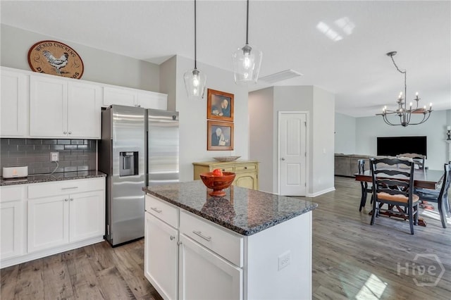346 Bobwhite Trl NE, Ludowici, GA 31316 - kitchen featuring stainless steel fridge with ice dispenser, a chandelier, light wood-type flooring, decorative backsplash, and open floor plan