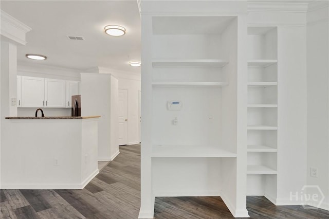3311 Whitemarsh Way Unit 3311, Savannah, GA 31410 - kitchen featuring freestanding refrigerator, white cabinetry, dark wood-type flooring, baseboards, and built in features