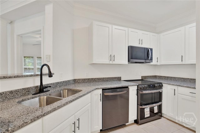 3311 Whitemarsh Way Unit 3311, Savannah, GA 31410 - kitchen featuring appliances with stainless steel finishes, a sink, white cabinets, light stone counters, and light tile patterned floors