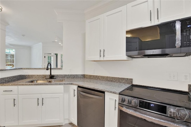 3311 Whitemarsh Way Unit 3311, Savannah, GA 31410 - kitchen featuring appliances with stainless steel finishes, a sink, crown molding, light stone counters, and white cabinetry