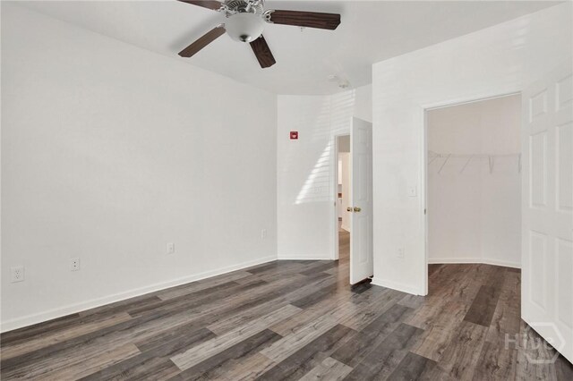 3311 Whitemarsh Way Unit 3311, Savannah, GA 31410 - unfurnished bedroom with a spacious closet, dark wood-style floors, a closet, a ceiling fan, and baseboards