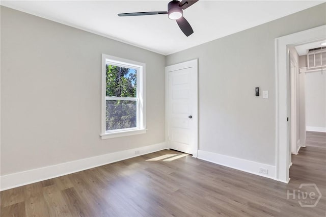 55 Saint Johns Ave, Savannah, GA 31404 - unfurnished bedroom featuring wood finished floors, baseboards, and attic access