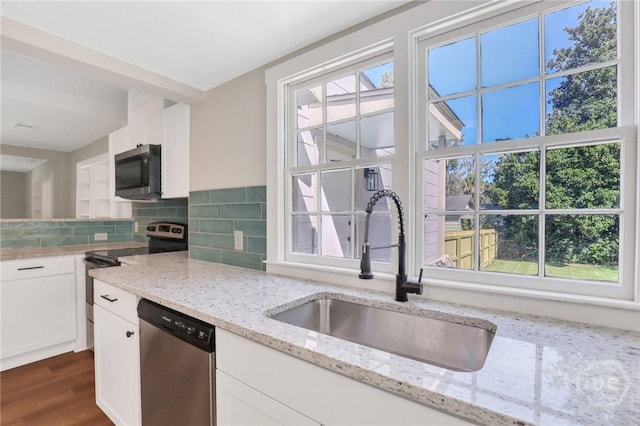 55 Saint Johns Ave, Savannah, GA 31404 - kitchen with a sink, appliances with stainless steel finishes, white cabinets, decorative backsplash, and dark wood-style floors