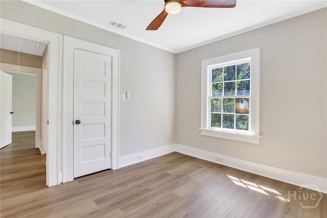 55 Saint Johns Ave, Savannah, GA 31404 - unfurnished room with attic access, wood finished floors, ceiling fan, baseboards, and ornamental molding