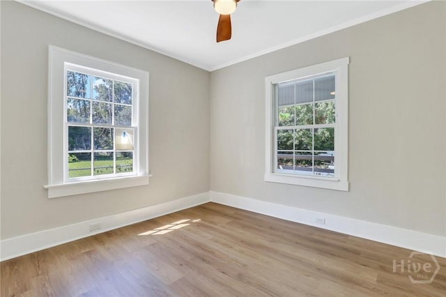 55 Saint Johns Ave, Savannah, GA 31404 - unfurnished room featuring healthy amount of natural light, baseboards, wood finished floors, and ornamental molding