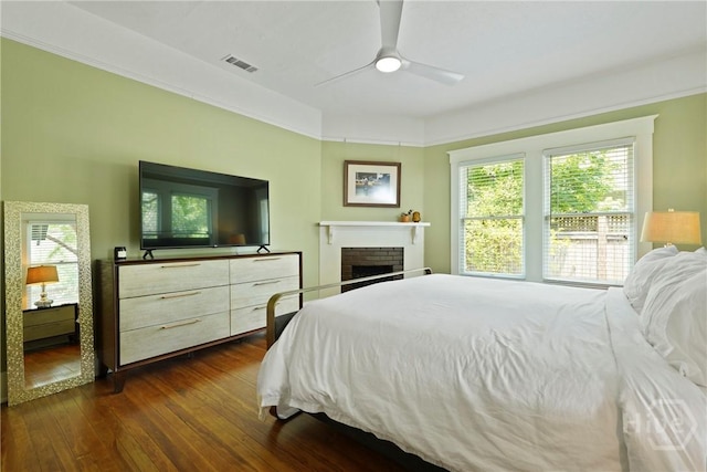 1301 E 48th St, Savannah, GA 31404 - bedroom featuring dark wood finished floors, ceiling fan, and a brick fireplace