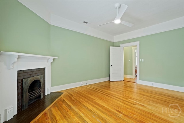 1301 E 48th St, Savannah, GA 31404 - unfurnished living room featuring a fireplace, ceiling fan, and wood finished floors