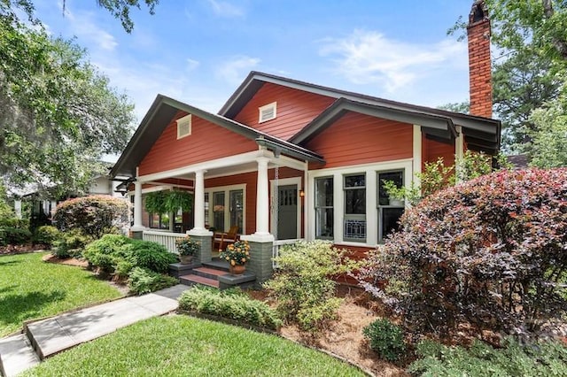 1301 E 48th St, Savannah, GA 31404 - view of front of property with covered porch, a chimney, and a front yard
