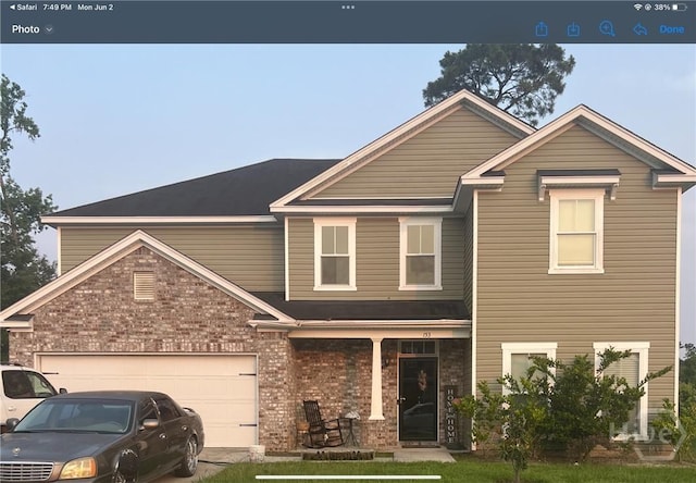 153 Spoonbill Cir, Savannah, GA 31405 - traditional home with a porch, brick siding, and a garage