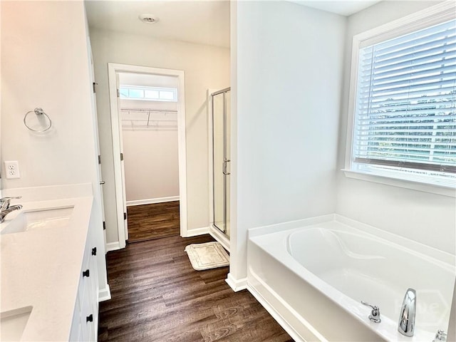 128 Melody Dr, Pooler, GA 31322 - bathroom with a shower stall, a garden tub, a spacious closet, double vanity, and wood finished floors