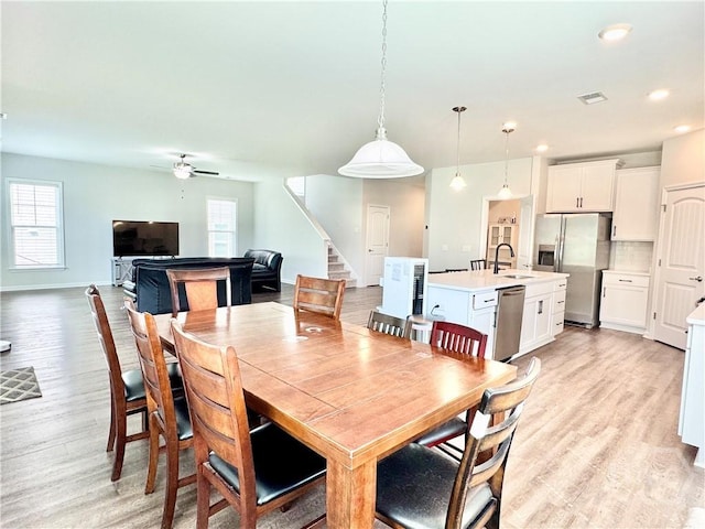 128 Melody Dr, Pooler, GA 31322 - dining room featuring stairs, light wood-type flooring, healthy amount of natural light, ceiling fan, and recessed lighting