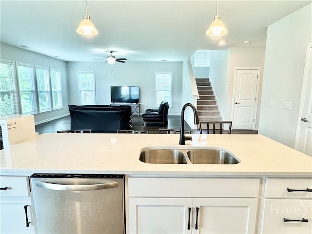 128 Melody Dr, Pooler, GA 31322 - kitchen featuring stainless steel dishwasher, a sink, open floor plan, white cabinets, and decorative light fixtures