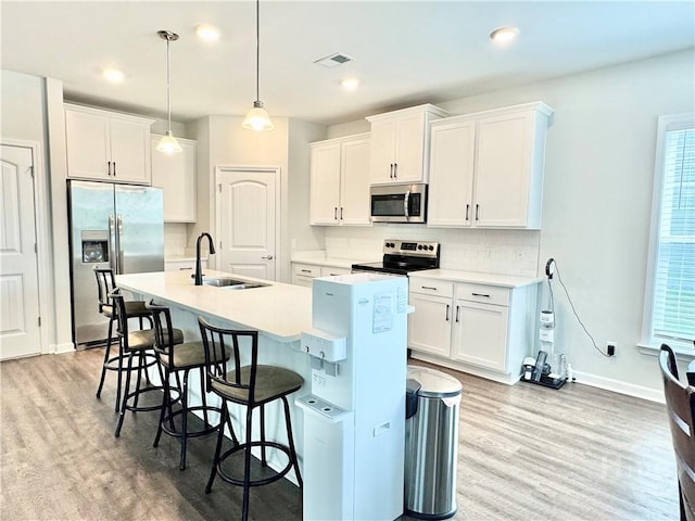 128 Melody Dr, Pooler, GA 31322 - kitchen featuring stainless steel appliances, a sink, light wood finished floors, decorative backsplash, and recessed lighting