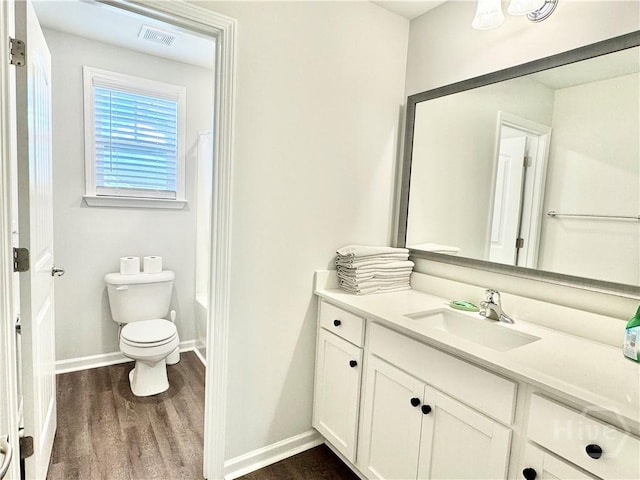 128 Melody Dr, Pooler, GA 31322 - full bath featuring vanity, wood finished floors, toilet, baseboards, and shower / bath combo