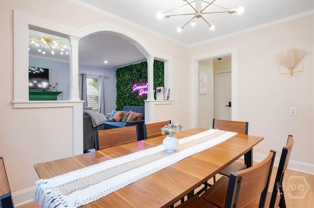 1706 E 31st St, Savannah, GA 31404 - dining room with arched walkways, wood finished floors, crown molding, a chandelier, and baseboards