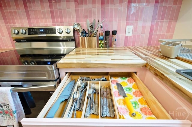 1706 E 31st St, Savannah, GA 31404 - kitchen with stainless steel range with electric cooktop, decorative backsplash, and wood counters