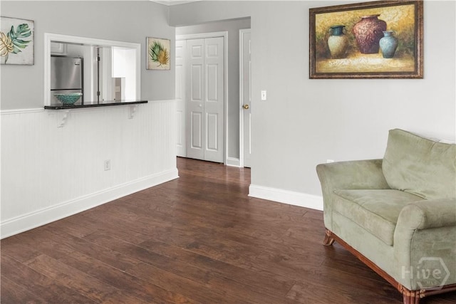 12300 Apache Ave Unit 507, Savannah, GA 31419 - living area with dark wood-style flooring, wainscoting, and baseboards