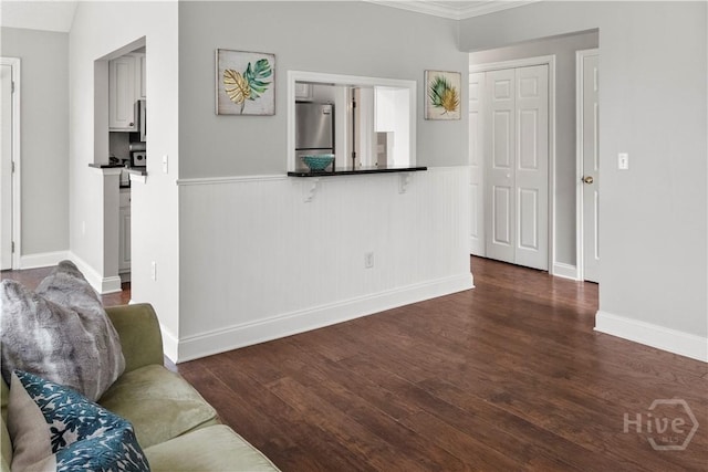 12300 Apache Ave Unit 507, Savannah, GA 31419 - living room with a wainscoted wall, dark wood-type flooring, and ornamental molding