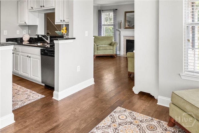 12300 Apache Ave Unit 507, Savannah, GA 31419 - kitchen with dishwasher, a sink, dark wood-style floors, dark countertops, and ornamental molding