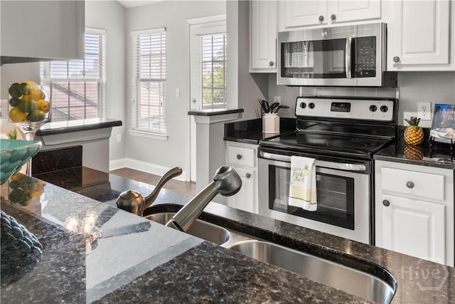 12300 Apache Ave Unit 507, Savannah, GA 31419 - kitchen with stainless steel appliances, healthy amount of natural light, and white cabinetry