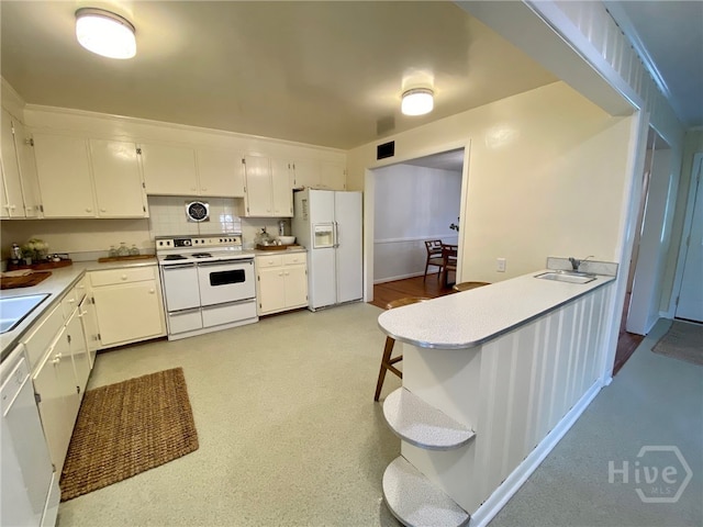 5524 Reynolds St, Savannah, GA 31405 - kitchen with white appliances, a sink, white cabinets, and light countertops