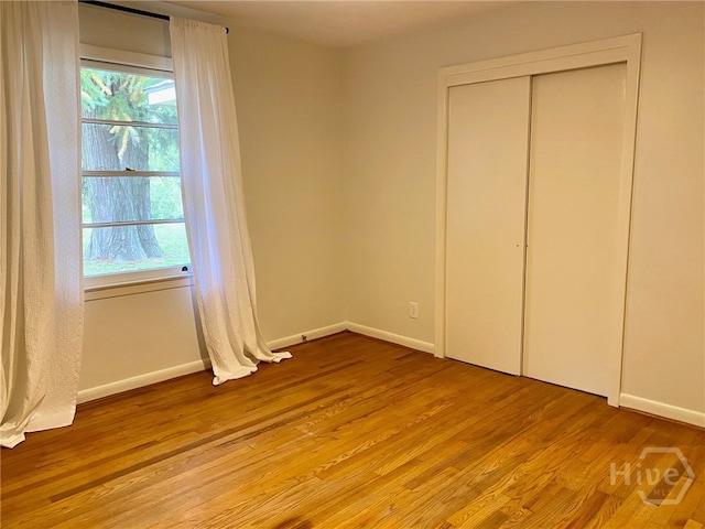 5524 Reynolds St, Savannah, GA 31405 - unfurnished bedroom featuring light wood-type flooring, baseboards, and a closet