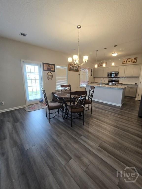 269 Brightleaf Cir, Hinesville, GA 31313 - dining space featuring dark wood-style flooring, a chandelier, and baseboards