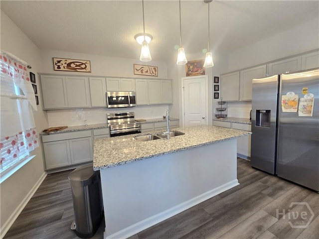 269 Brightleaf Cir, Hinesville, GA 31313 - kitchen with appliances with stainless steel finishes, a sink, dark wood finished floors, and a kitchen island with sink