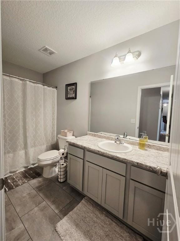 269 Brightleaf Cir, Hinesville, GA 31313 - bathroom with vanity, toilet, tile patterned floors, a textured ceiling, and a shower with shower curtain