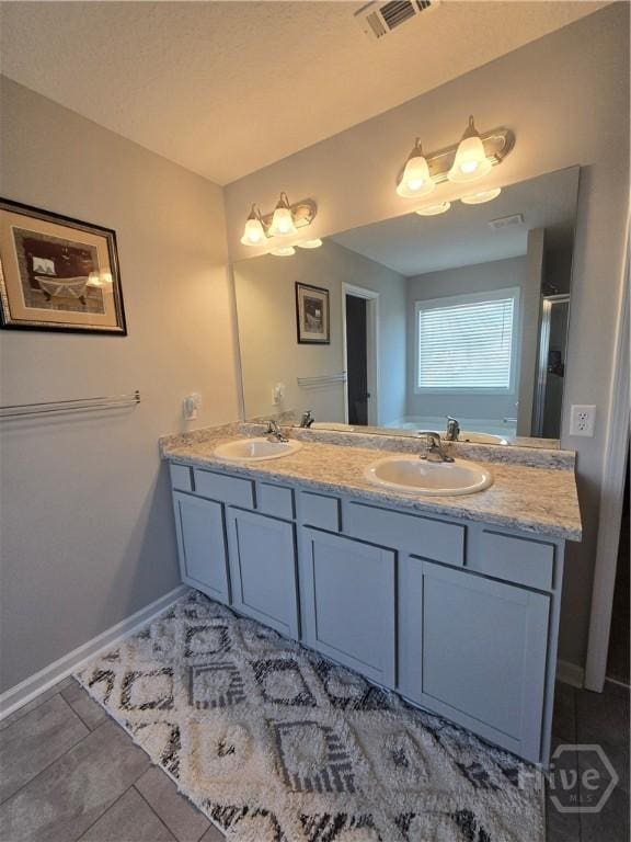 269 Brightleaf Cir, Hinesville, GA 31313 - bathroom featuring double vanity, baseboards, and tile patterned floors