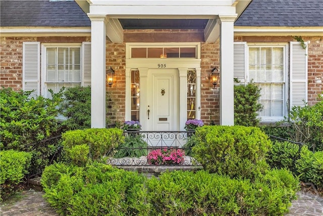 905 Goebel Ave, Savannah, GA 31404 - entrance to property with roof with shingles, covered porch, and brick siding