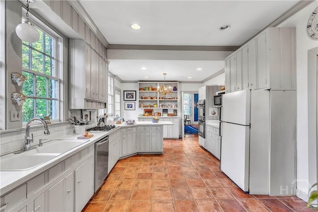 905 Goebel Ave, Savannah, GA 31404 - kitchen featuring a sink, plenty of natural light, freestanding refrigerator, stainless steel dishwasher, and ornamental molding