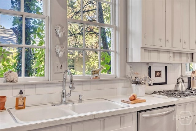 905 Goebel Ave, Savannah, GA 31404 - kitchen with a sink, stainless steel appliances, tasteful backsplash, and white cabinetry