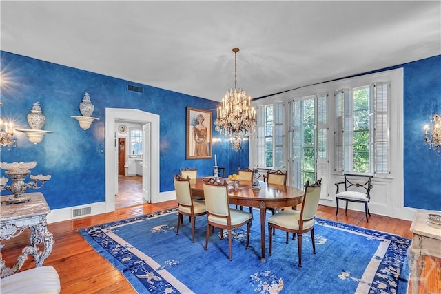 905 Goebel Ave, Savannah, GA 31404 - dining room featuring hardwood / wood-style floors, baseboards, and a chandelier