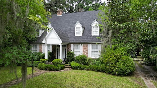 905 Goebel Ave, Savannah, GA 31404 - cape cod-style house with a front yard, brick siding, roof with shingles, and a chimney