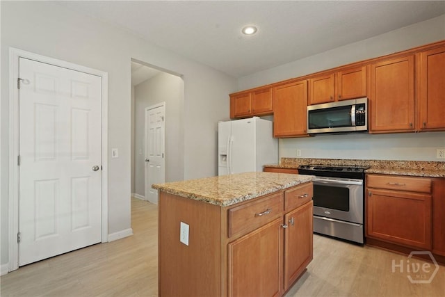 130 Willow Point Cir, Savannah, GA 31407 - kitchen with stainless steel appliances, light wood finished floors, a kitchen island, light stone counters, and recessed lighting
