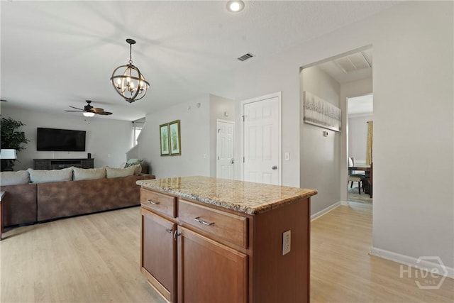 130 Willow Point Cir, Savannah, GA 31407 - kitchen with a ceiling fan, a chandelier, light wood-type flooring, light stone countertops, and pendant lighting
