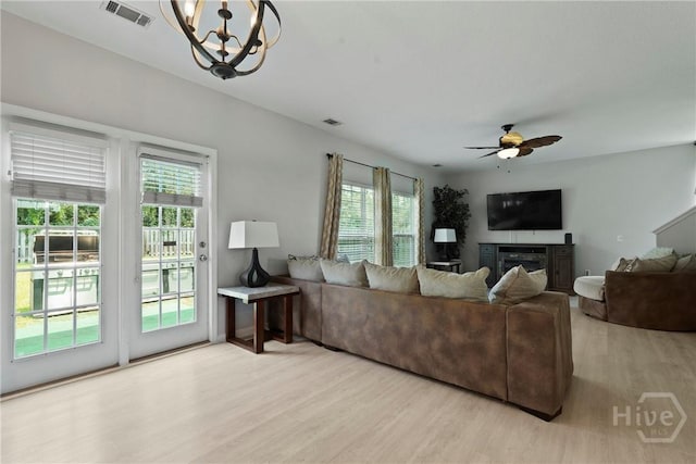 130 Willow Point Cir, Savannah, GA 31407 - living area with wood finished floors, healthy amount of natural light, ceiling fan, and a glass covered fireplace