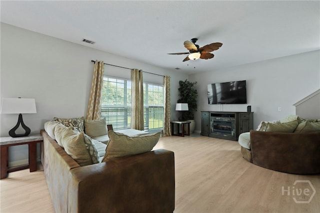 130 Willow Point Cir, Savannah, GA 31407 - living room featuring light wood-type flooring, ceiling fan, and a fireplace